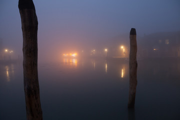 Night view canal on Murano island in the fog