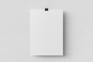 Blank paper poster hanging on binder clip