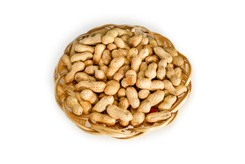 Peanuts. Dry whole nuts on bamboo plate isolated on white background.