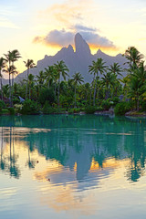 View of the Mont Otemanu mountain reflecting in water at sunset in Bora Bora, French Polynesia,...