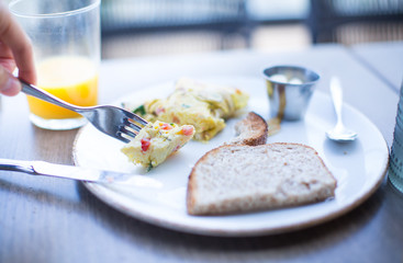 Eating Eggs and Toasted Bread for Healthy and Delicious Breakfast or Snack.  Morning Food with Scrambled Tasty Eggs. Balanced Diet and Health Weight Control. Simple Nutrition with Natural Ingredients.