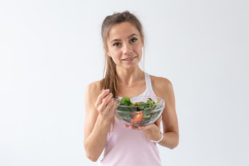 People, food and diet concept - Portrait of woman eating healthy food over white background
