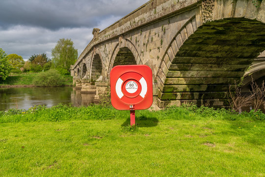 A lifebuoy at Atcham Old Bridge over the River Severn in Atcham, near Shrewsbury, Shropshire, England, UK