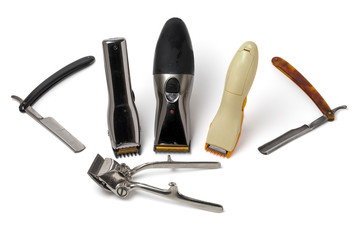 Vintage straight razor, old manual hair clipper and electric hair clippers isolated on white background. Barbershop tools