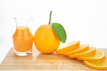 Orange juice and oranges with leaves