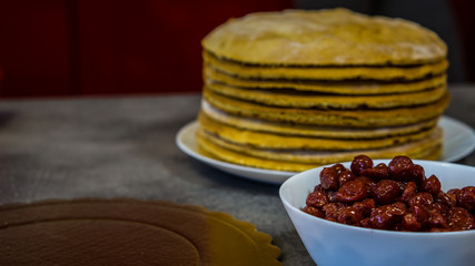 Making a homemade cherry pie, on a stone table, biscuits, cherries, cake stand