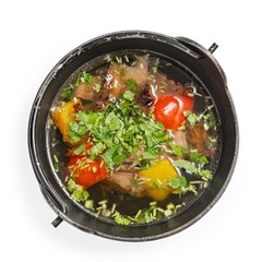 Soup with meat and vegetables, top view, on white background