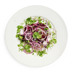 Vegetable salad on a plate, top view, on a white background