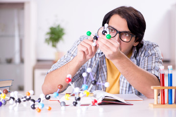 Young student physicist preparing for exam at home    