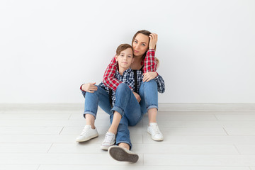 Mothers day, children and family concept - Beautiful woman and her son on white background