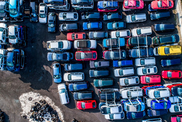 Lines of crushed cars wreck in scrapyard before being shredded recyling