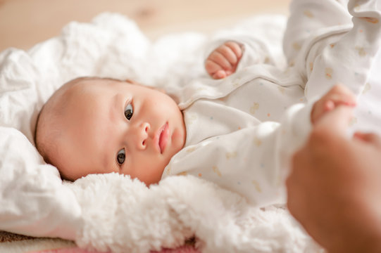 Cute baby boy in a white light bedroom Newborn baby is cute. In bedding for children born - images