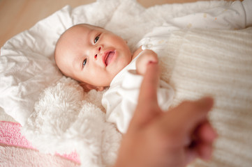 Cute baby boy in a white light bedroom Newborn baby is cute. In bedding for children born - images