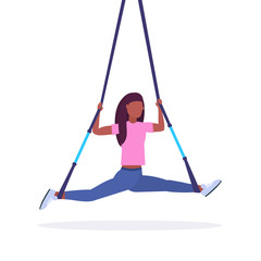 sporty woman doing splits exercises with suspension fitness straps elastic rope african american girl training in gym crossfit cardio workout concept flat white background full length