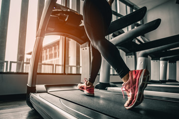Close up on shoe,Women running in a gym on a treadmill.exercising concept.fitness and healthy...