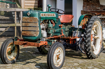 Old American tractor in good condition at farm yard restored looking vintage slightly rusty