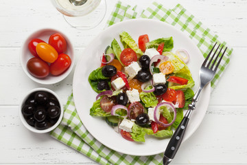 Greek salad plate and white wine