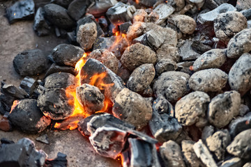 Charcoal on the grill starts to glow