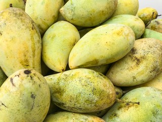 Many yellow mango piles