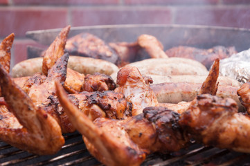 Hot wings with sausages on the grill