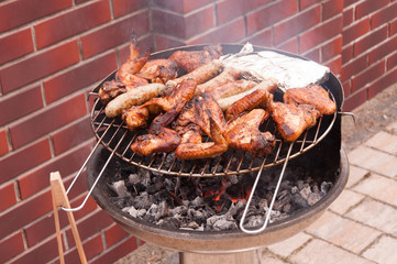 Hot wings with sausages on the grill