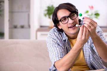 Young student physicist preparing for exam at home    