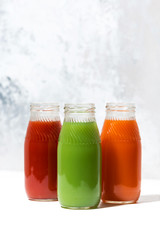 colorful vegetable juices in bottles, vertical
