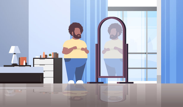 Sad Overweight Man Looking At Himself Reflection In Mirror African American Guy Over Size Obesity Concept Modern Apartment Bedroom Interior Flat Full Length Horizontal