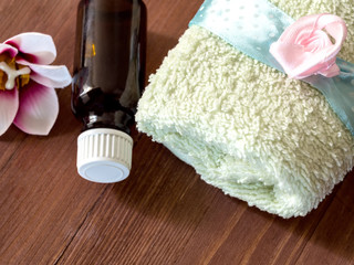 Top view of the towel and bottle of oil.