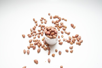 Peanuts in small cups isolated on white background