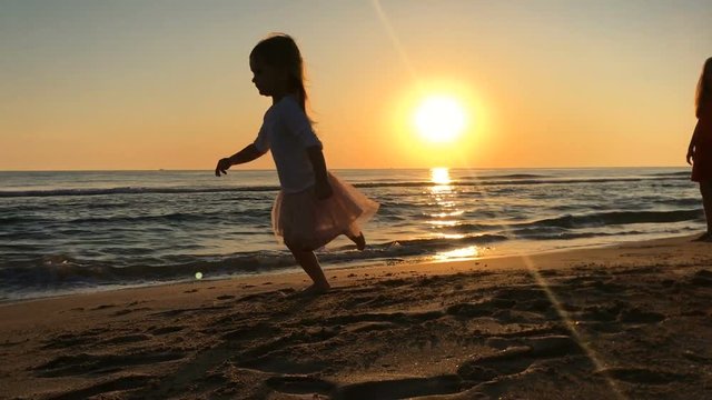 Little girl running down the beach.