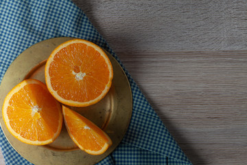 Sliced orange on a golden plate