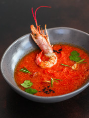 Gazpacho red soup with prawns shrimps (tomato soup with seafood) serving. food background. copy space