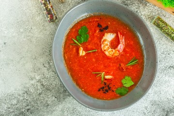 Gazpacho red soup with prawns shrimps (tomato soup with seafood) serving. food background. copy space