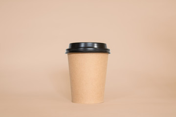 Disposable coffee cup on a brown background