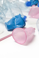 Crumpled single-use plastic waste, studio shot.  Plastic pollution concept. Single-use plastic is a human addiction that is destroying our planet and impacts our waters, sea life and humans.