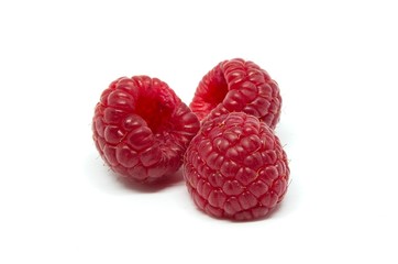 Raspberries over white background