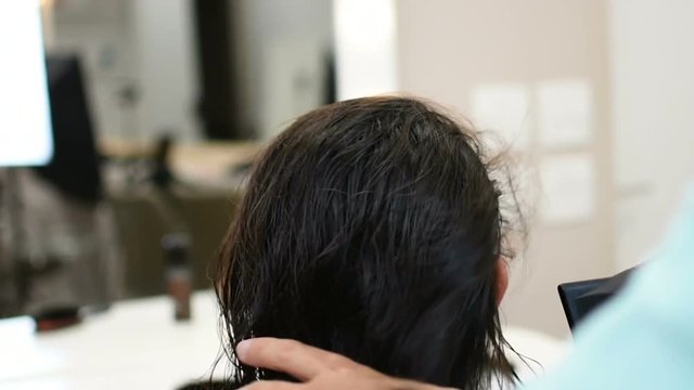Professional drying of long black hair in beauty saloon, slow motion