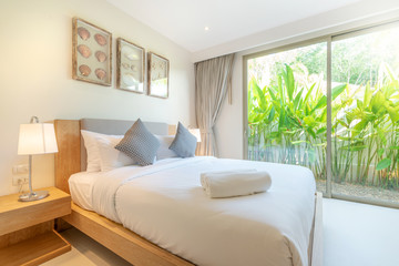 real Luxury Interior design in bedroom of pool villa with cozy king bed with high raised ceiling home, house ,building