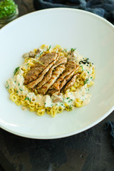 roast meat, pasta fine Annellini and creamy sauce (main dish). food background. top view