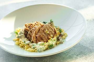 roast meat, pasta fine Annellini and creamy sauce (main dish). food background. top view