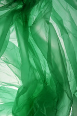 Naklejka na ściany i meble Polyethylene bag background. Crumpled plastic bag background in green color. Background as a template for text and design.