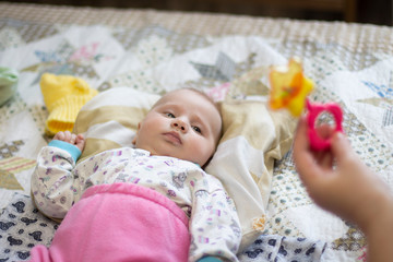 little newborn girl lying on the bed