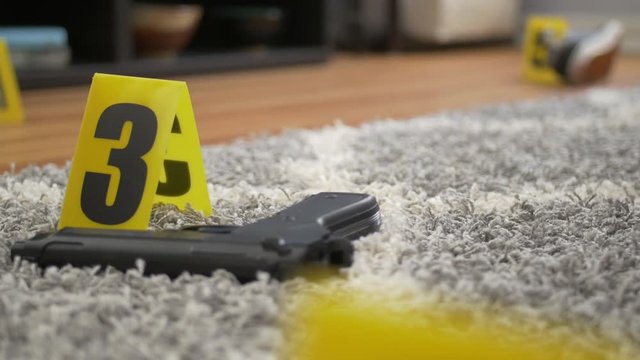 Dolly Shot of Gun Left at Crime Scene