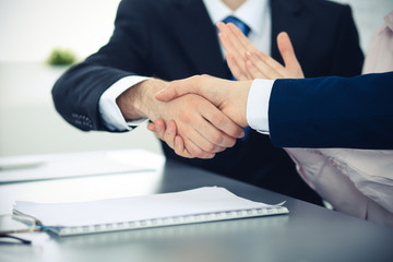 Business people shaking hands finishing up a meeting. Handshake at successful negotiation