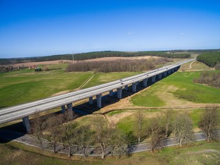 highway bridge in rural area - aerial view of a big highway bridge in rural area in germany european - cars drive over the highway bridge - drone flight