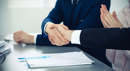 Business people shaking hands finishing up a meeting. Handshake at successful negotiation