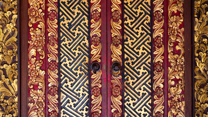 Beautifully decorated Indonesian wooden door in black red and gold