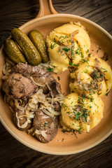 Fried chicken liver with onion served with mashed potatoes and pickled cucumber.