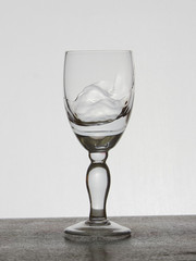 Spray liquid (clear water, red wine) from a glass goblet.